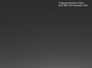 Tiangong and Shenzou spacecraft moving across the pre-dawn sky.
