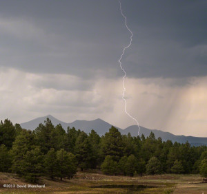 Cloud-to-ground lightning with the San Francisco Peaks in the distance.