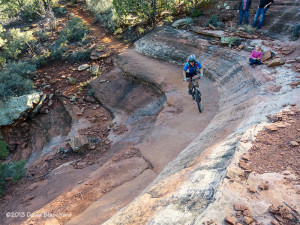 Taking the turn on a sandstone bench on Aerie Trail in Sedona.