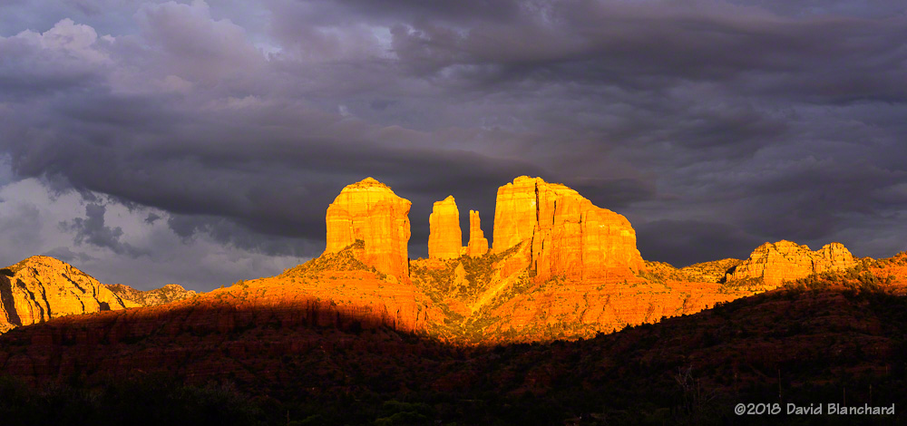 Late afternoon sun briefly lights up Cathedral Rock in Sedona.