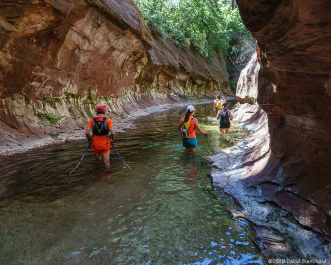 Wading through the water in the first narrows in West Fork.