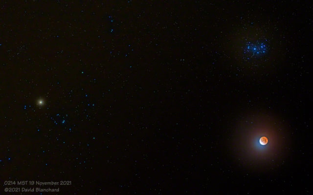 Lunar eclipse with the Pleiades and Hyades star clusters.