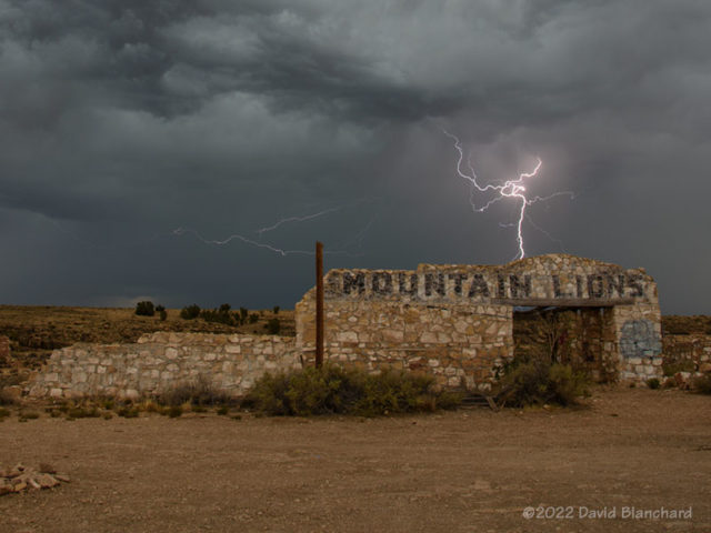 Lightning behind the ruins at Two Guns, Arizona.