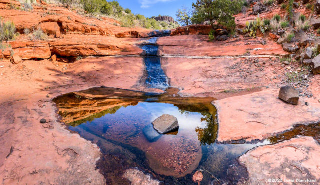 Pano image of water flowing down the shallow canyon on Scheurman Mountain.