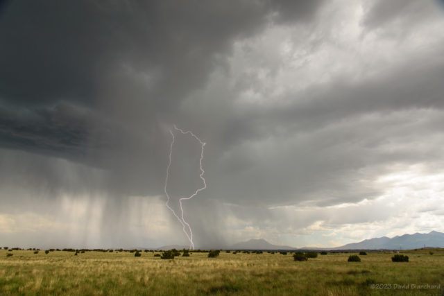 A couple of lighting bolts over the grasslands of Wupatki National Monument.