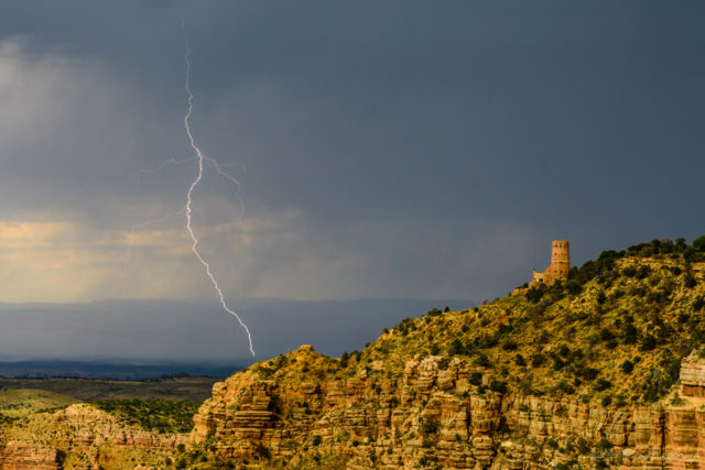 Lightning flashes over the Little Colorado River Valley east of Desert View Watch Tower in Grand Canyon.