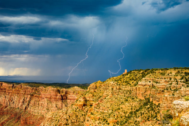 Lightning flashes over the Little Colorado River Valley east of Desert View Watch Tower in Grand Canyon.
