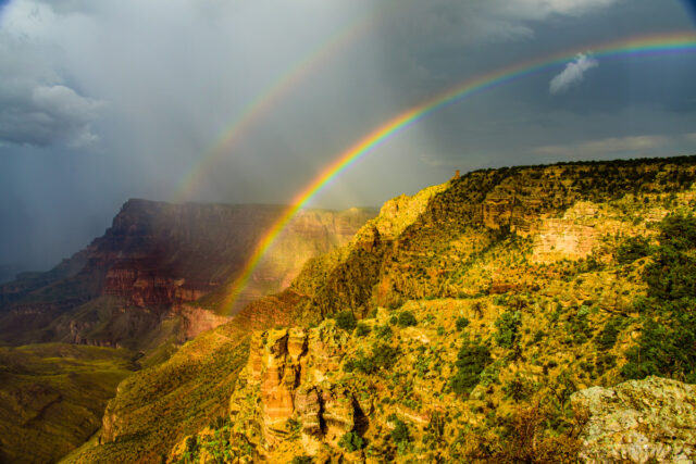 A double rainbow over Palisades of the Canyon and Desert View Tower in Grand Canyon.