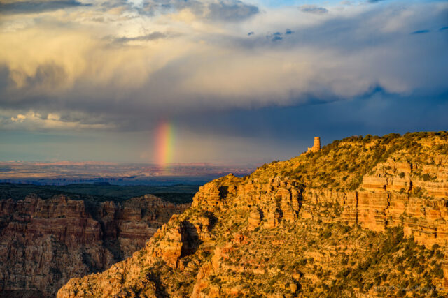 A short segment of a rainbow with Desert View Tower.