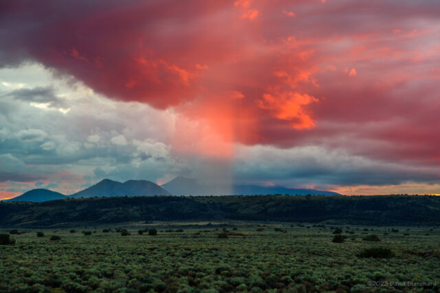 A burst of color on a rain shaft at sunset over Wupatki National Monument.