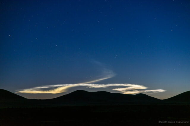 Noctilucent clouds from the rocket exhaust linger into twilight.