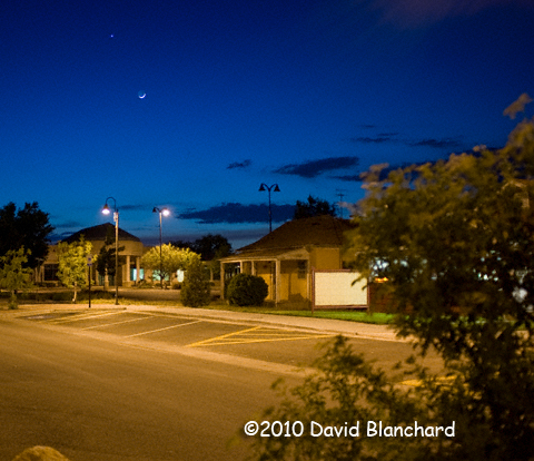 A view of the crescent moon and Venus at twilight as seen from downtown Artesia, New Mexico.